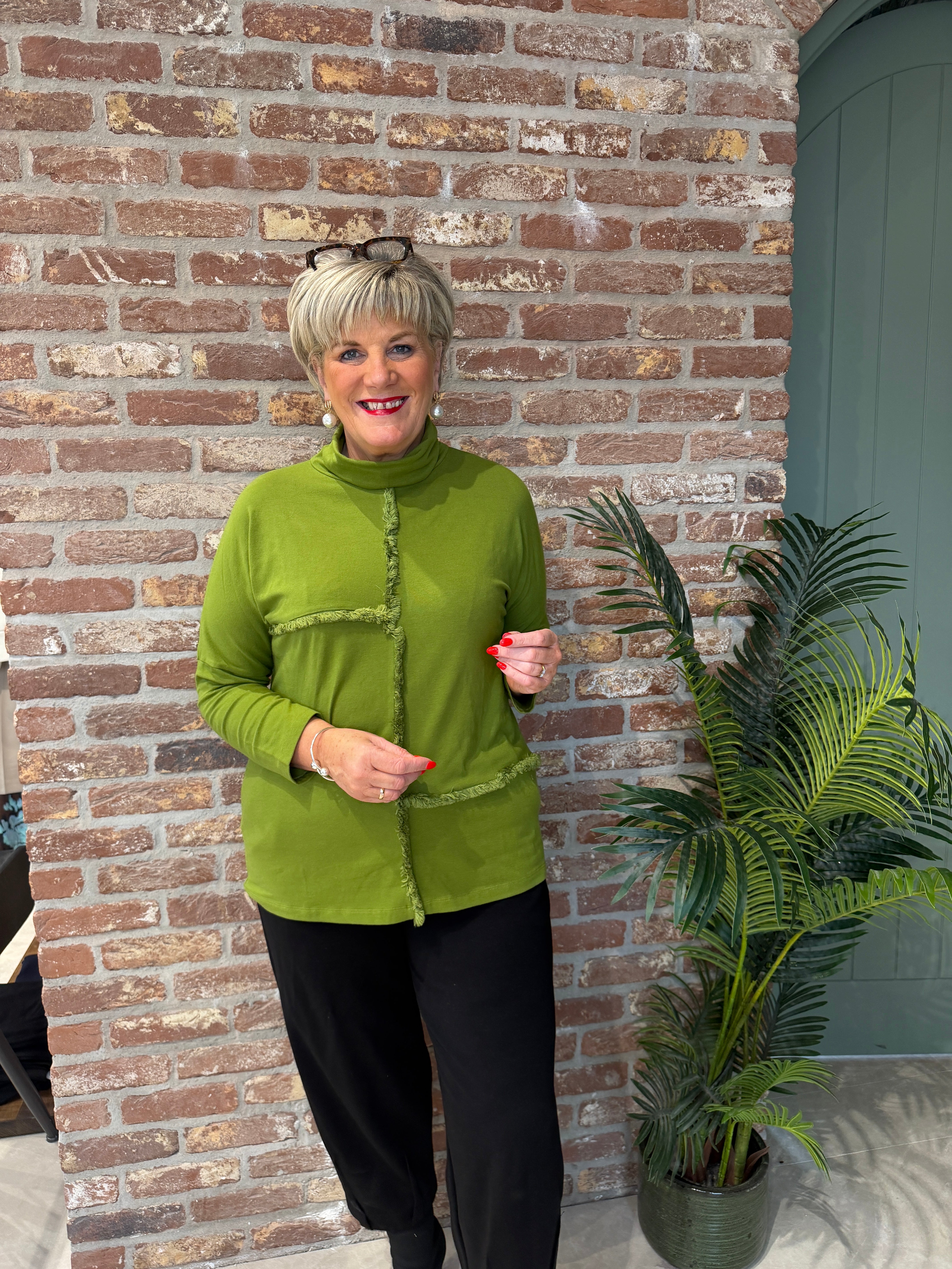 Roll neck top with frill edge detail in green
