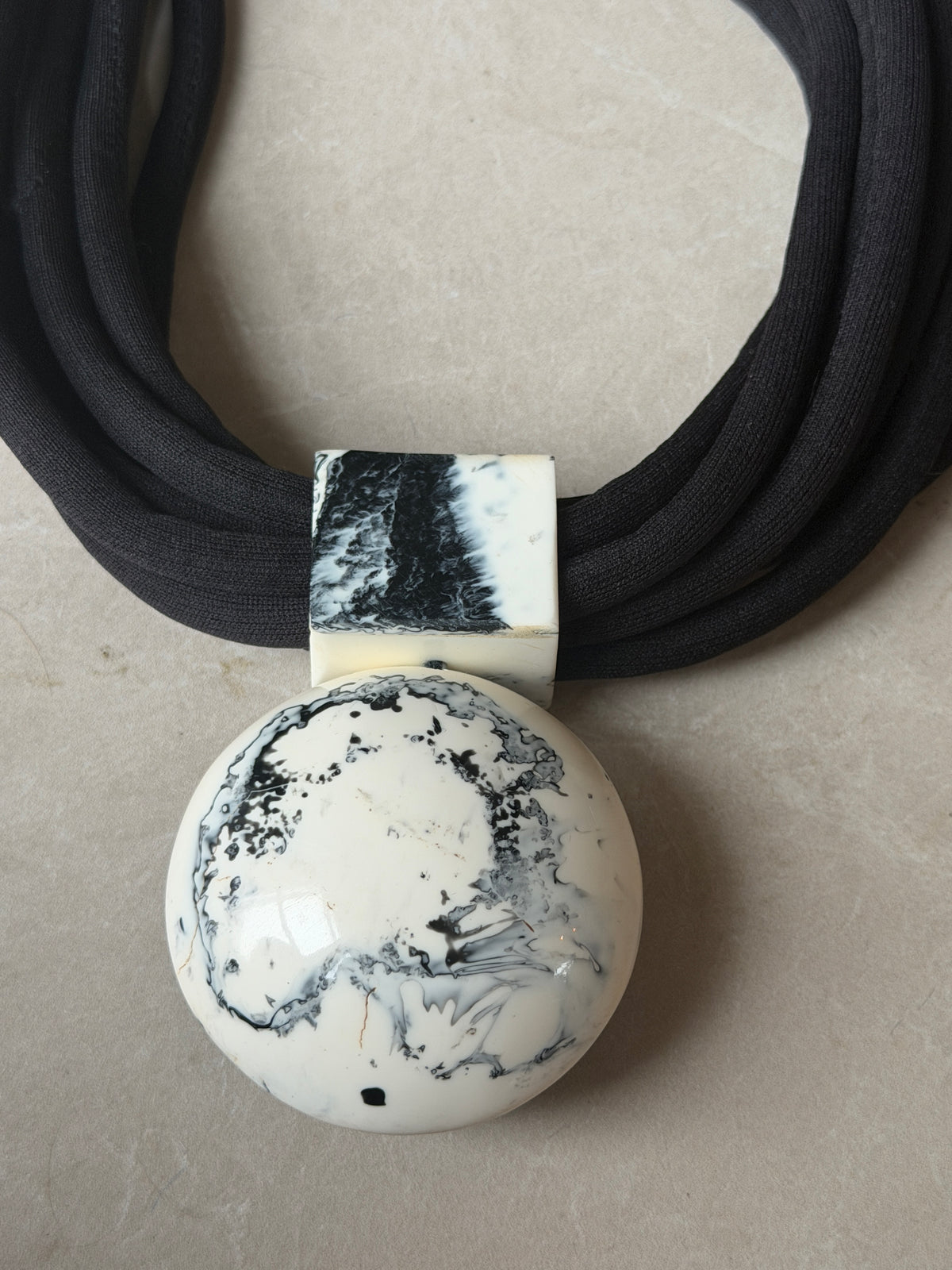 Multiple strand fob necklace in black & cream