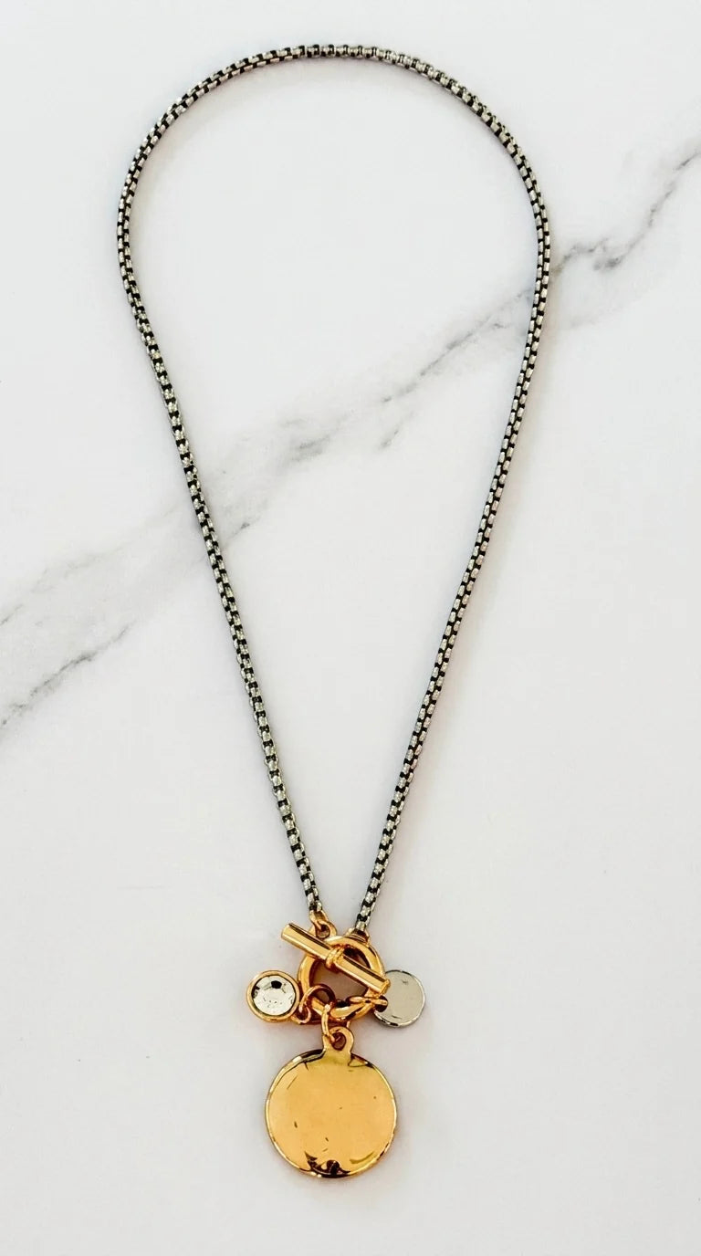 Short silver snake chain necklace with gold T-bar and circle pendant