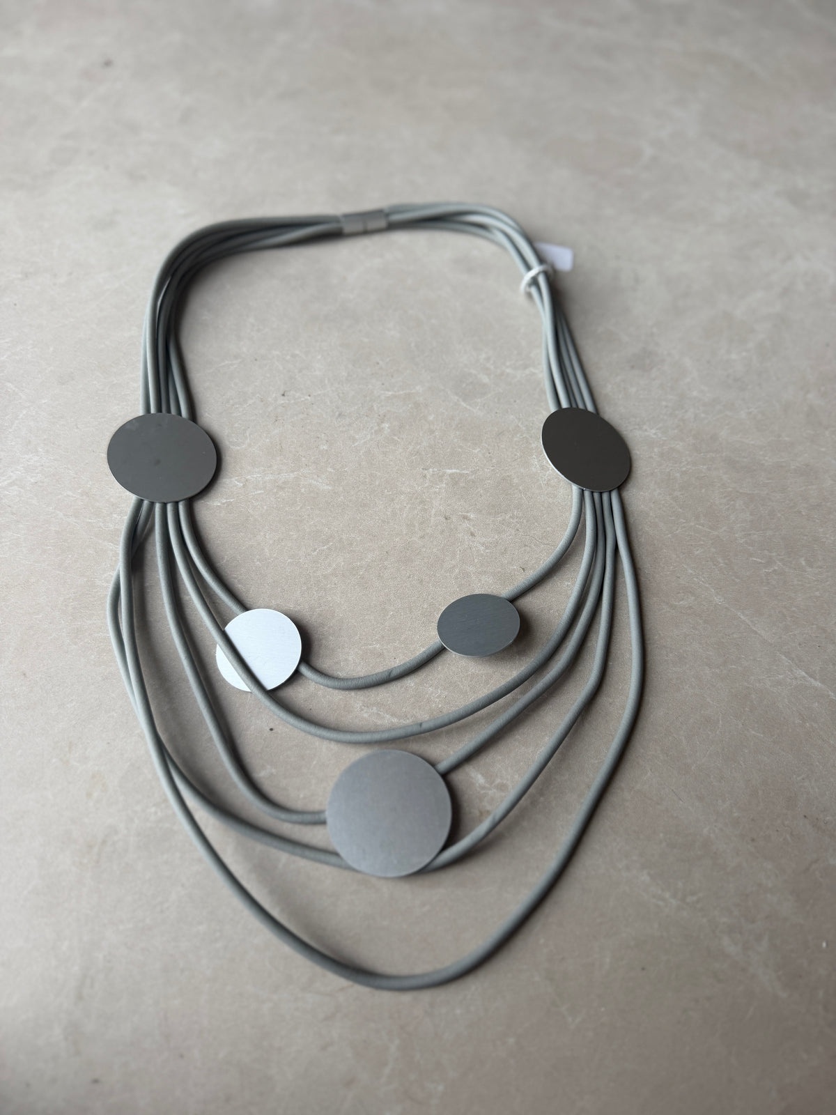 Tiered rubber & disk necklace in grey