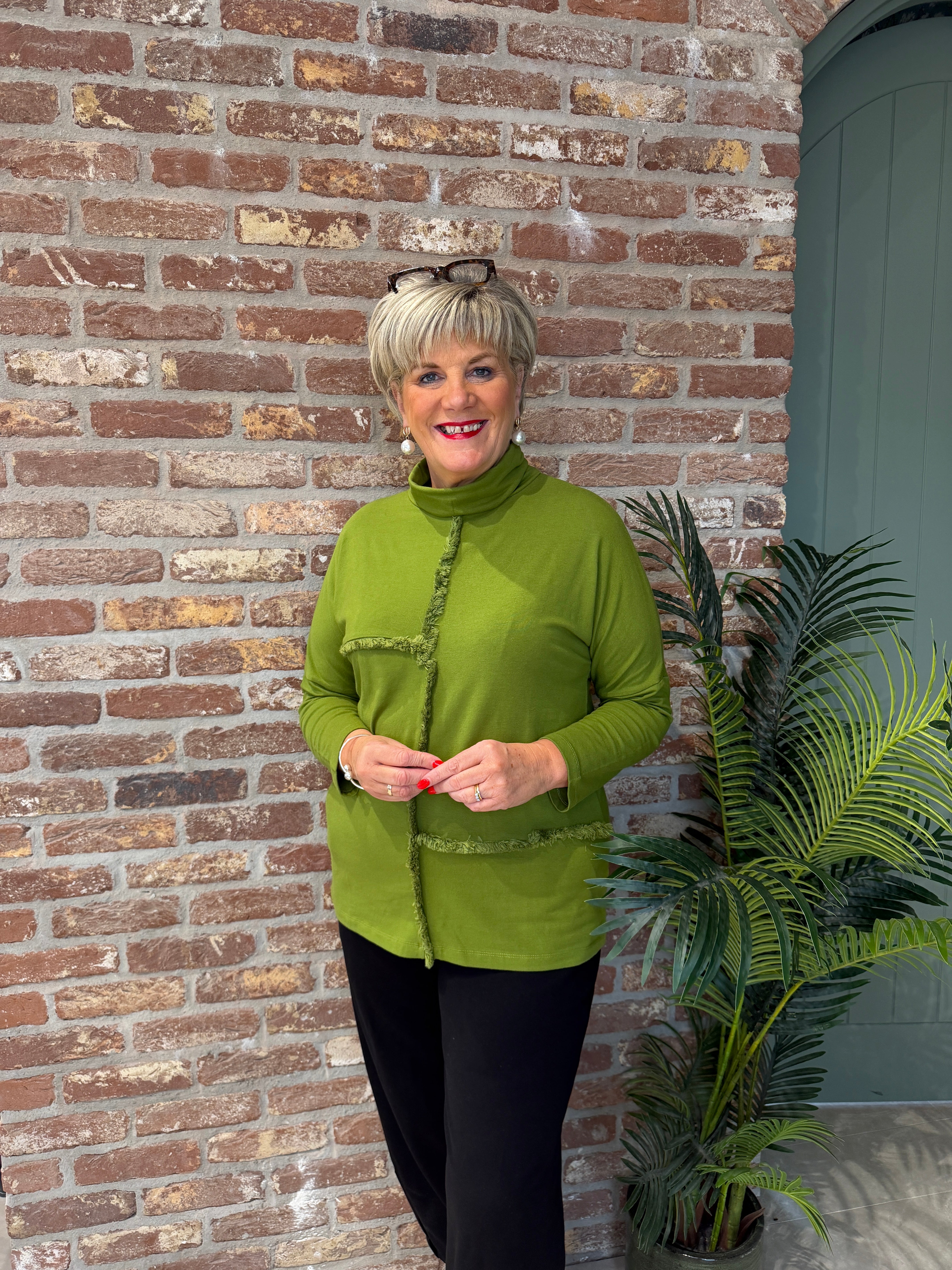 Roll neck top with frill edge detail in green
