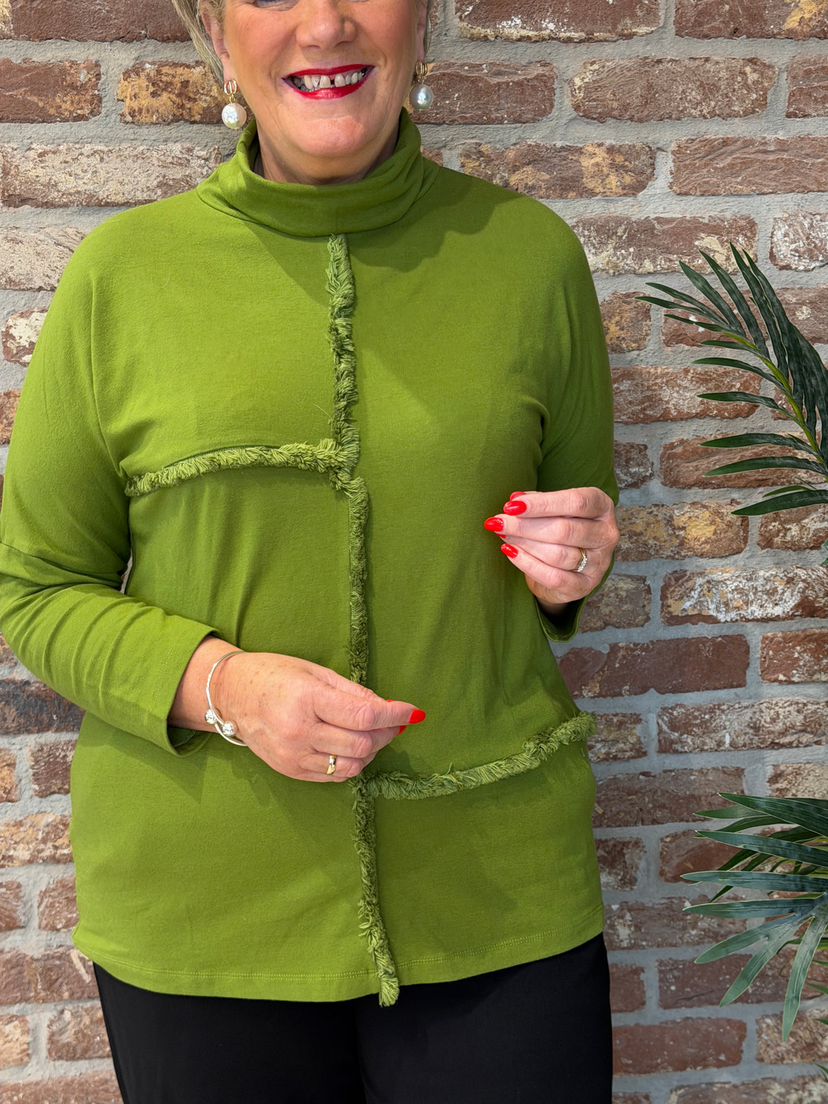 Roll neck top with frill edge detail in green