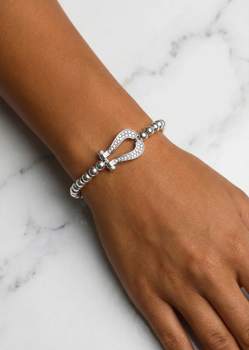 Silver bead stretch bracelet with a cristal horseshoe