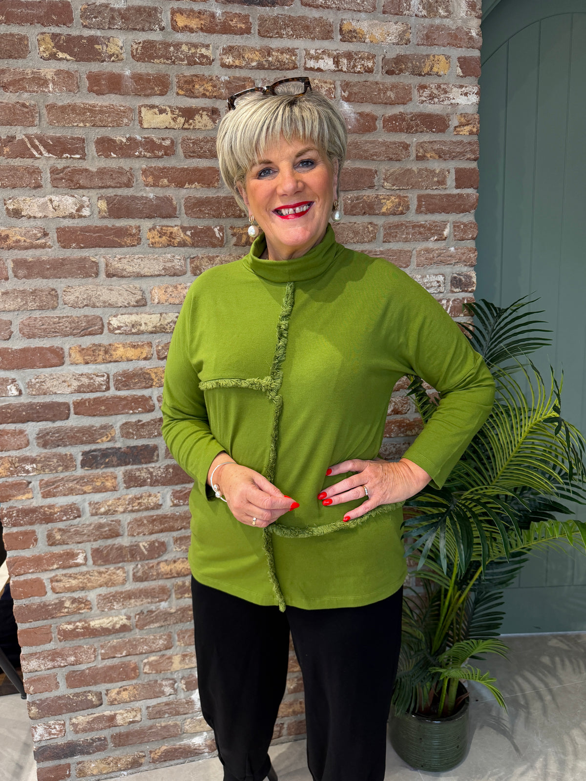 Roll neck top with frill edge detail in green