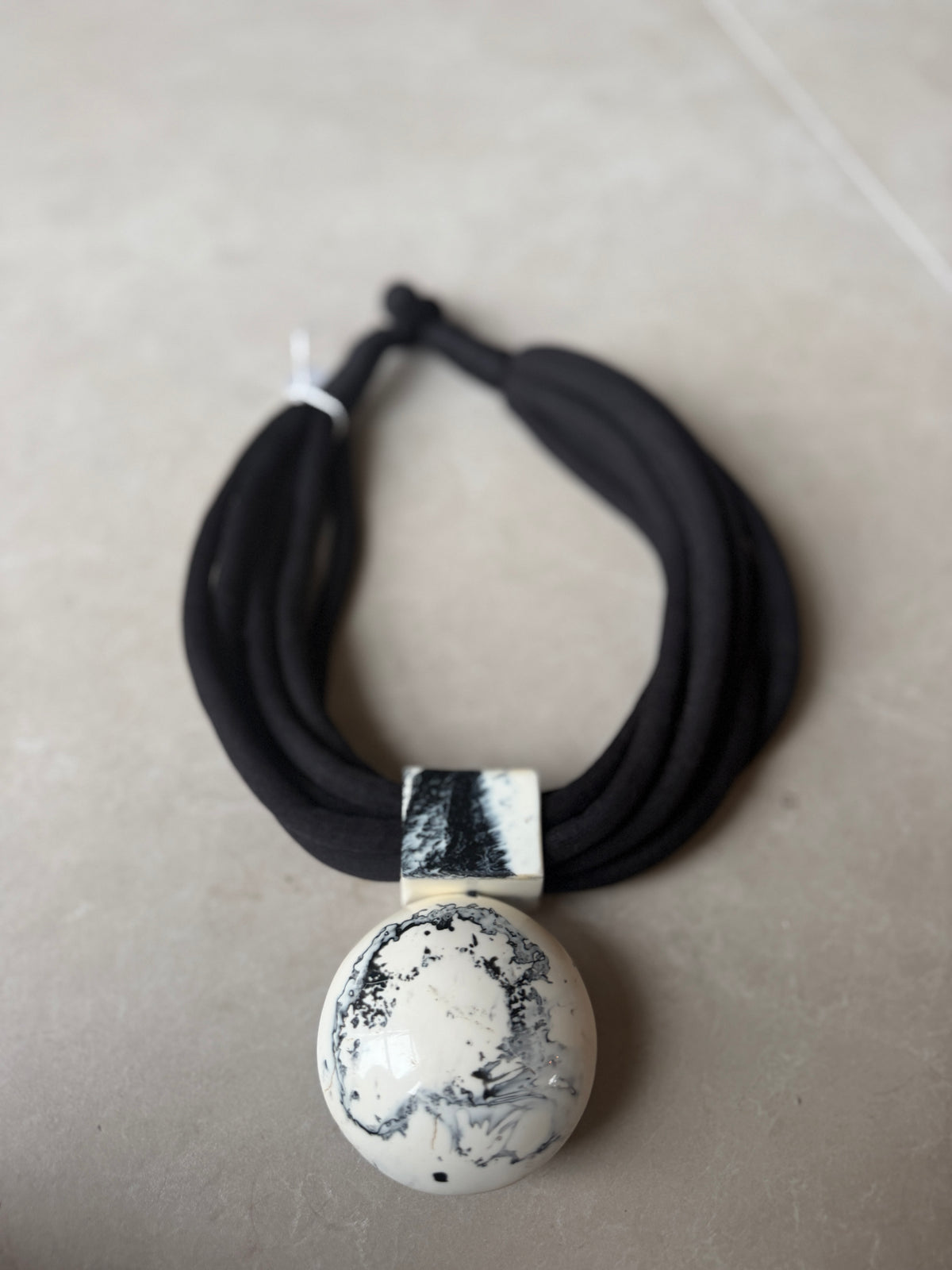 Multiple strand fob necklace in black & cream