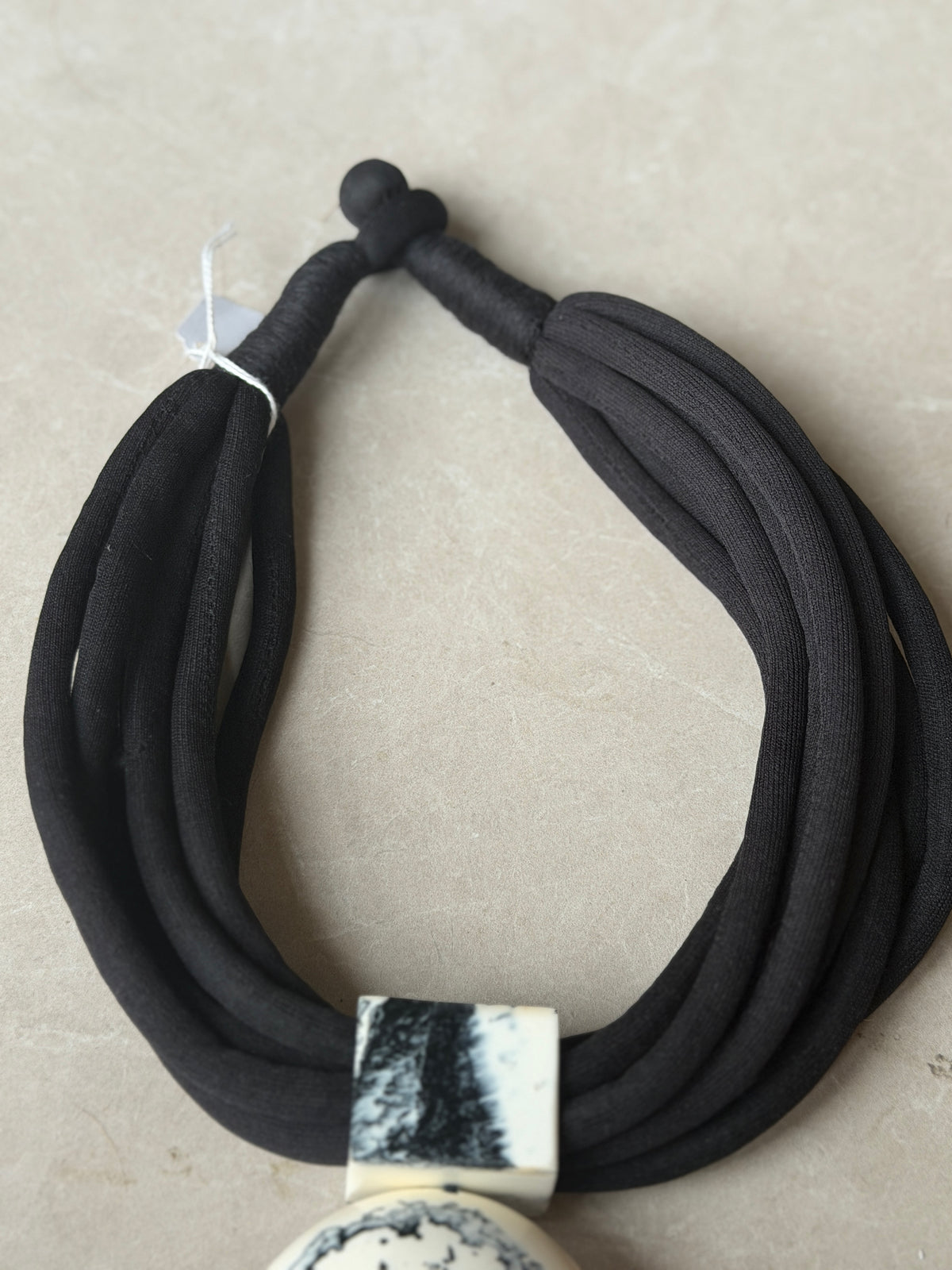 Multiple strand fob necklace in black & cream