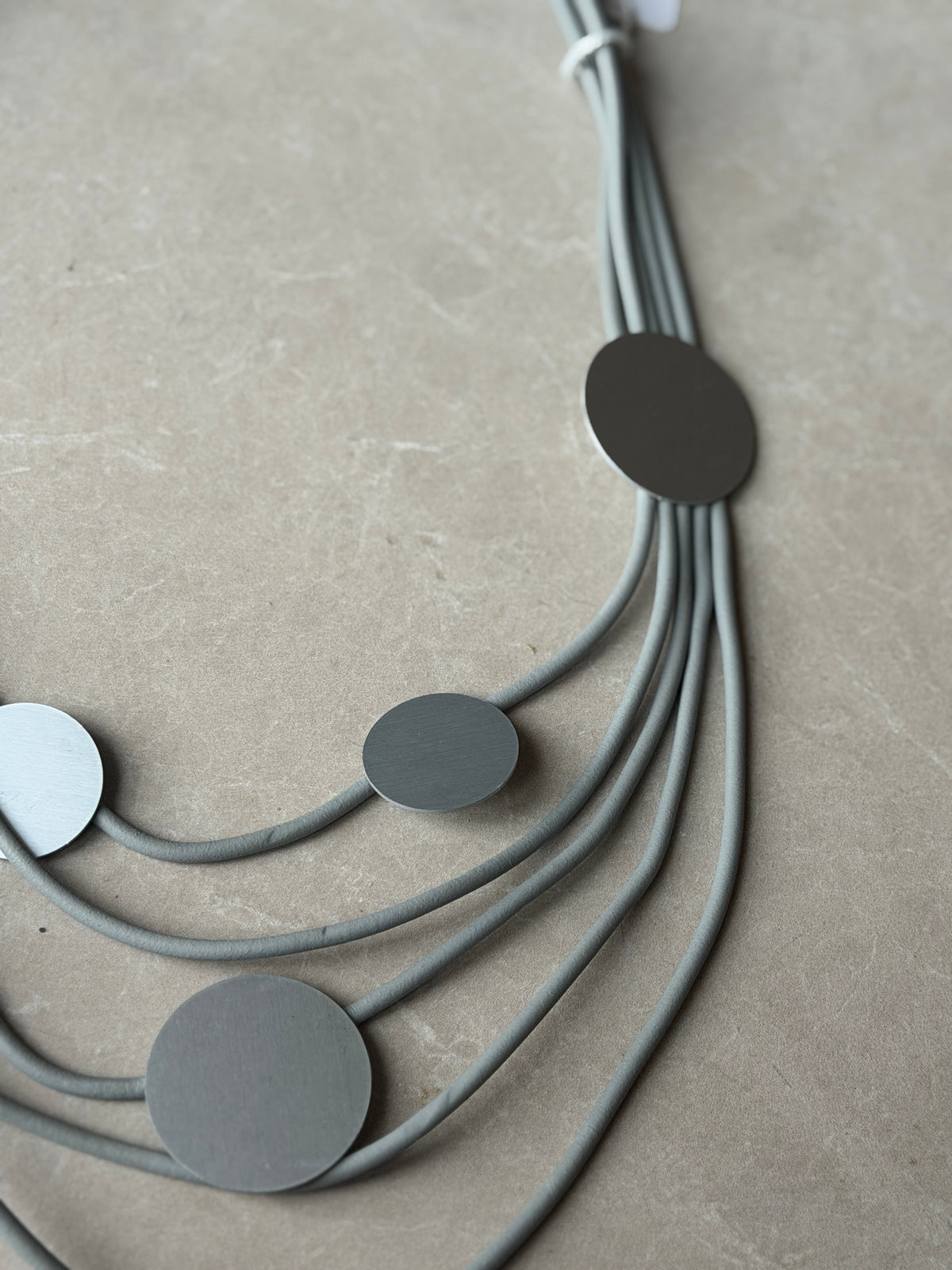 Tiered rubber & disk necklace in grey